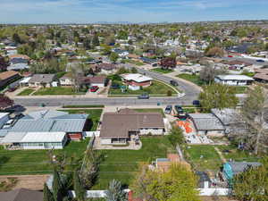Aerial view of property and surrounding area with nearby suburban area