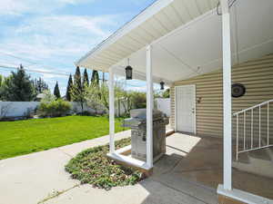 Porch featuring area for grilling and a fenced backyard