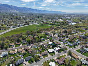 Aerial view of property and surrounding area featuring nearby suburban area