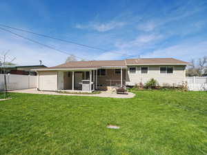 Rear view of property featuring a patio area and a shingled roof