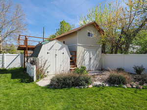 View of shed with a fenced backyard