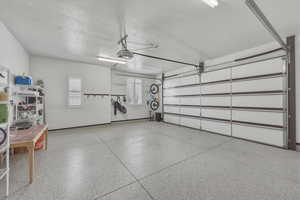 Garage featuring baseboards and a garage door opener