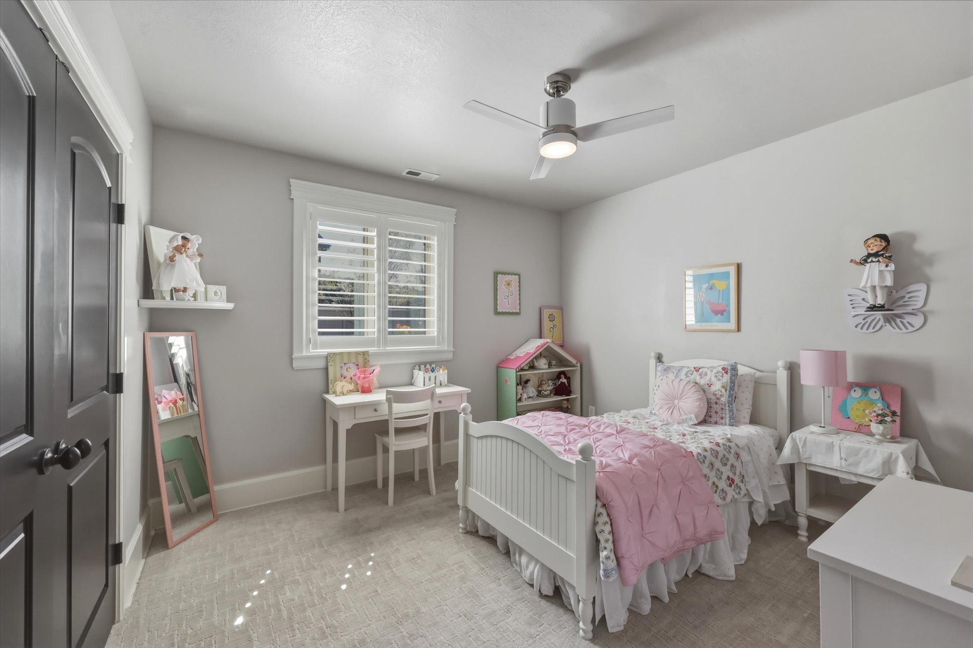 Bedroom with a ceiling fan and light colored carpet
