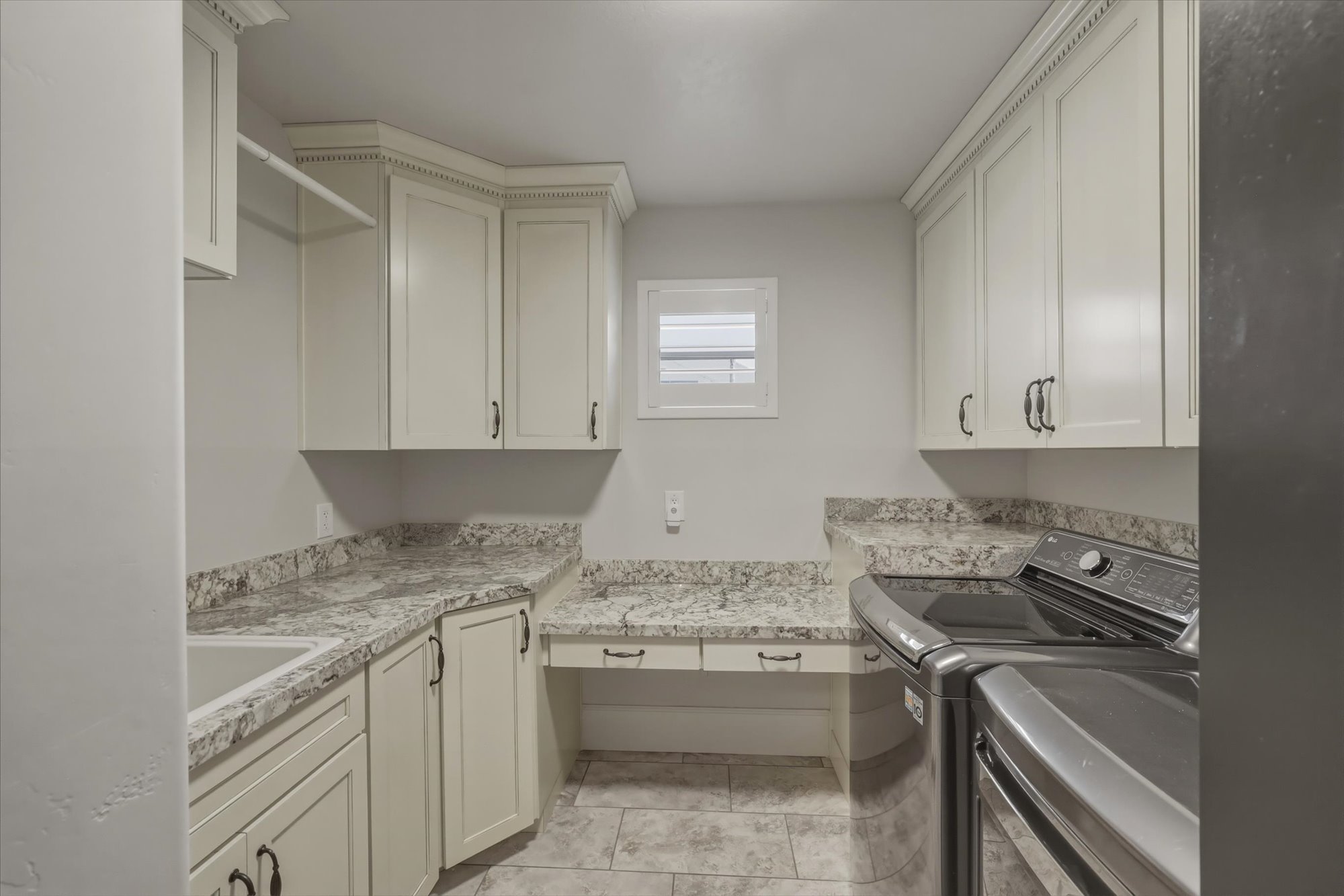 Laundry room with separate washer and dryer and cabinet space