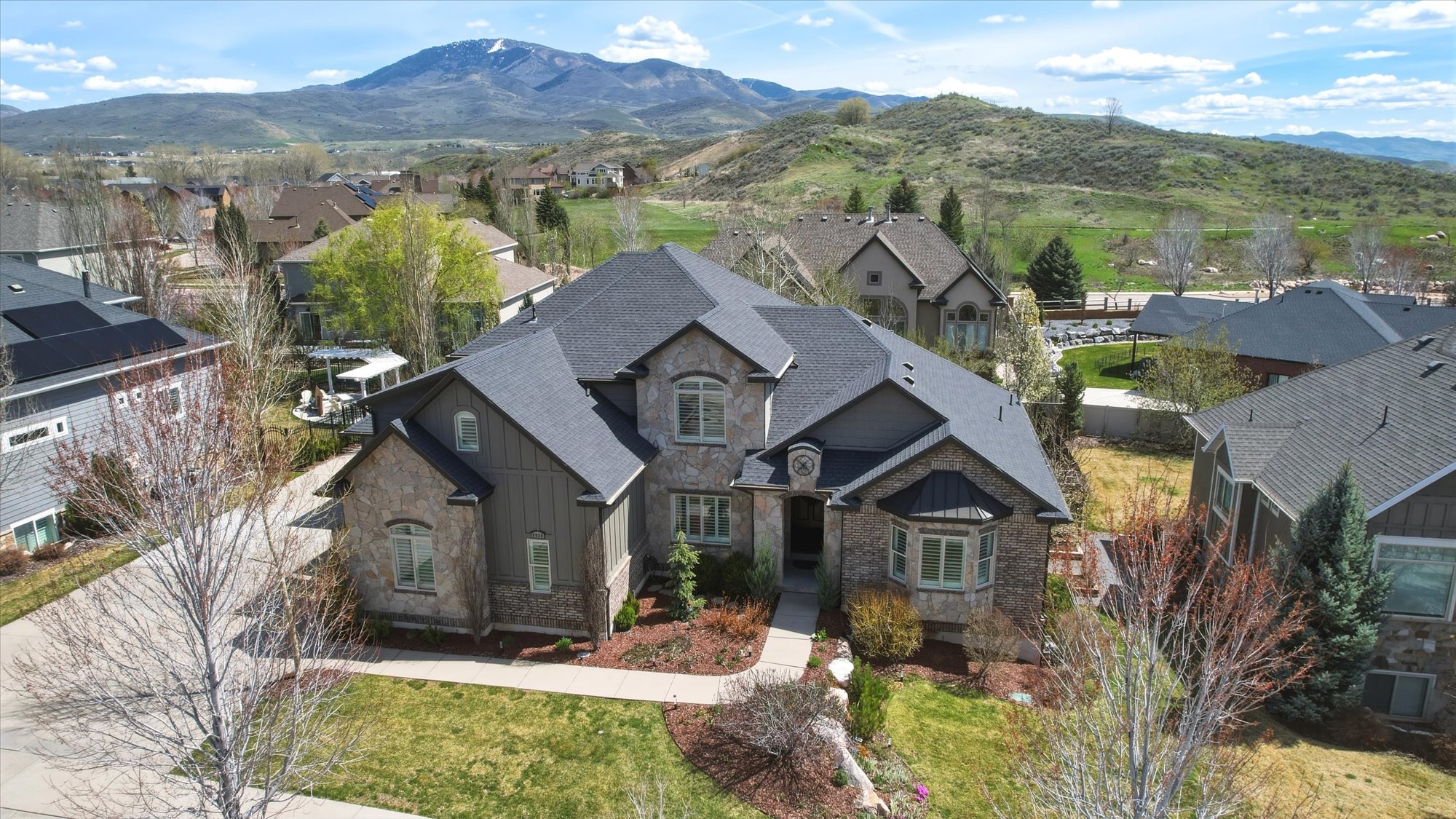 Aerial perspective of suburban area featuring a mountain backdrop