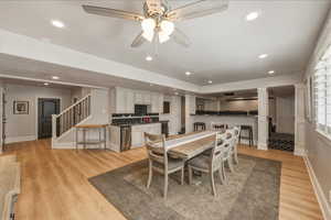 Dining space featuring ornate columns, recessed lighting, light wood finished floors, and a ceiling fan