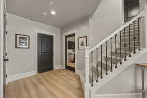 Foyer featuring light wood finished floors and recessed lighting