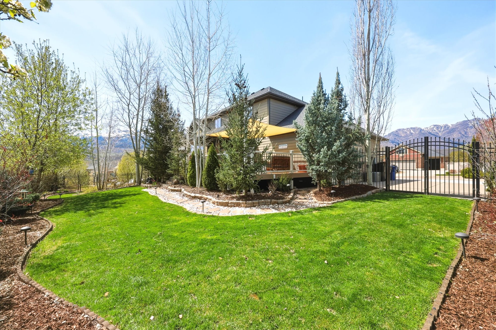 View of yard with a gate and a mountain view