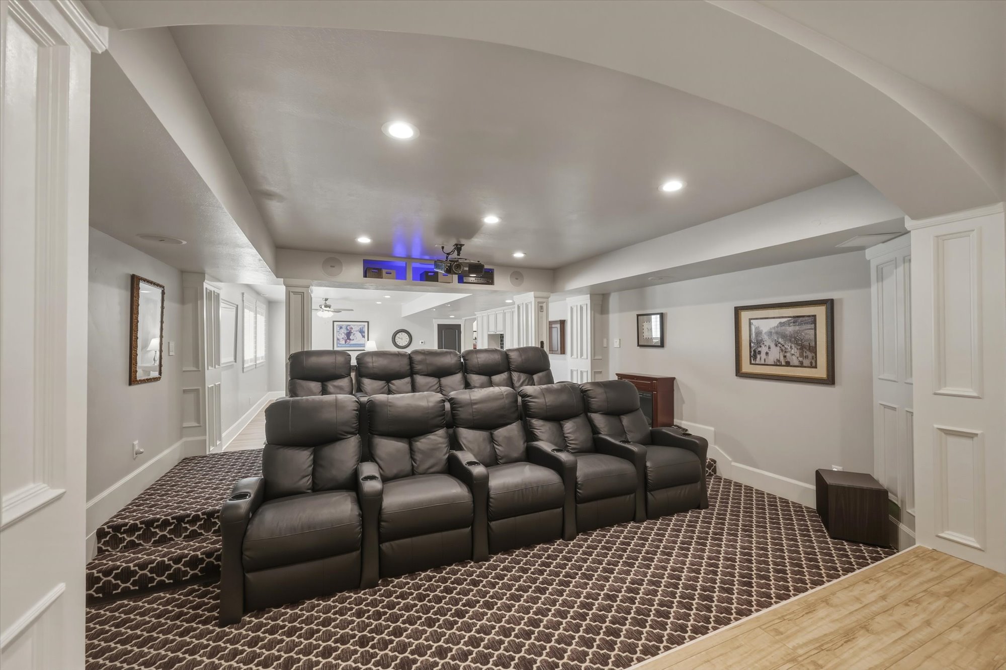 Cinema with recessed lighting and dark colored carpet