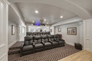 Cinema with recessed lighting and dark colored carpet