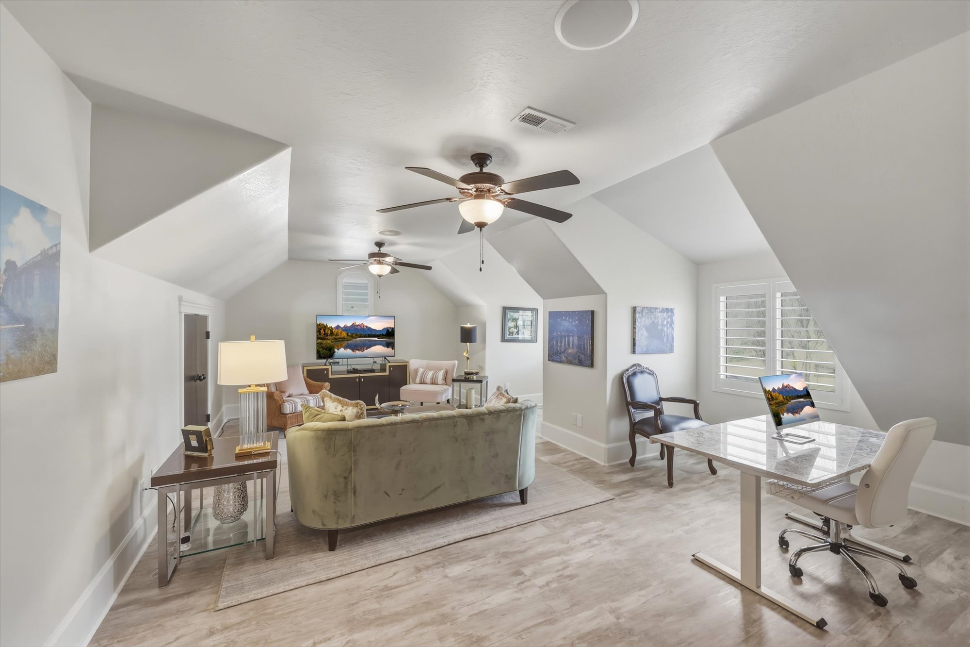 Bedroom featuring an office area, lofted ceiling, light wood-style flooring, and ceiling fan