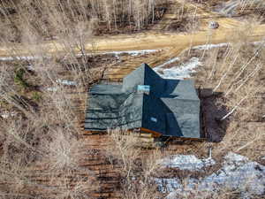View of subject property with a tree filled landscape