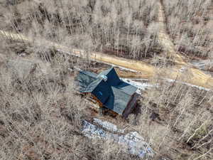 View from above of property with a tree filled landscape
