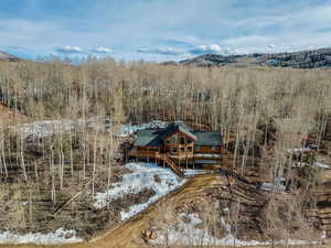 Snowy aerial view featuring a mountain view
