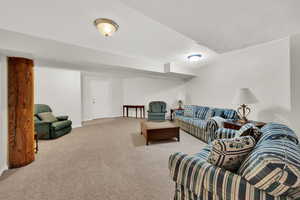 Living room featuring light colored carpet and baseboards