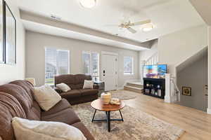 Living room featuring a ceiling fan and wood finished floors