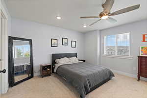 Bedroom featuring light carpet, ceiling fan, and recessed lighting