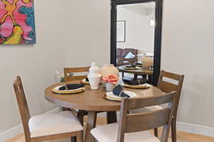 Dining room with baseboards and light wood-type flooring