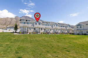 View of front of house featuring a front lawn and board and batten siding