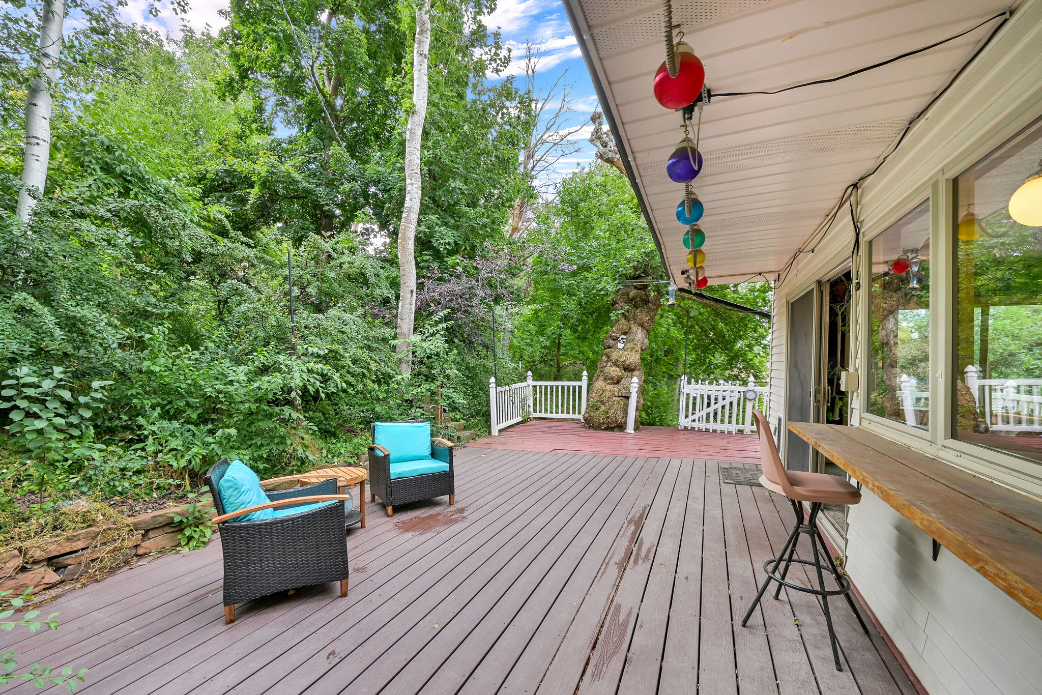 Back deck with lush green backdrop of mature trees