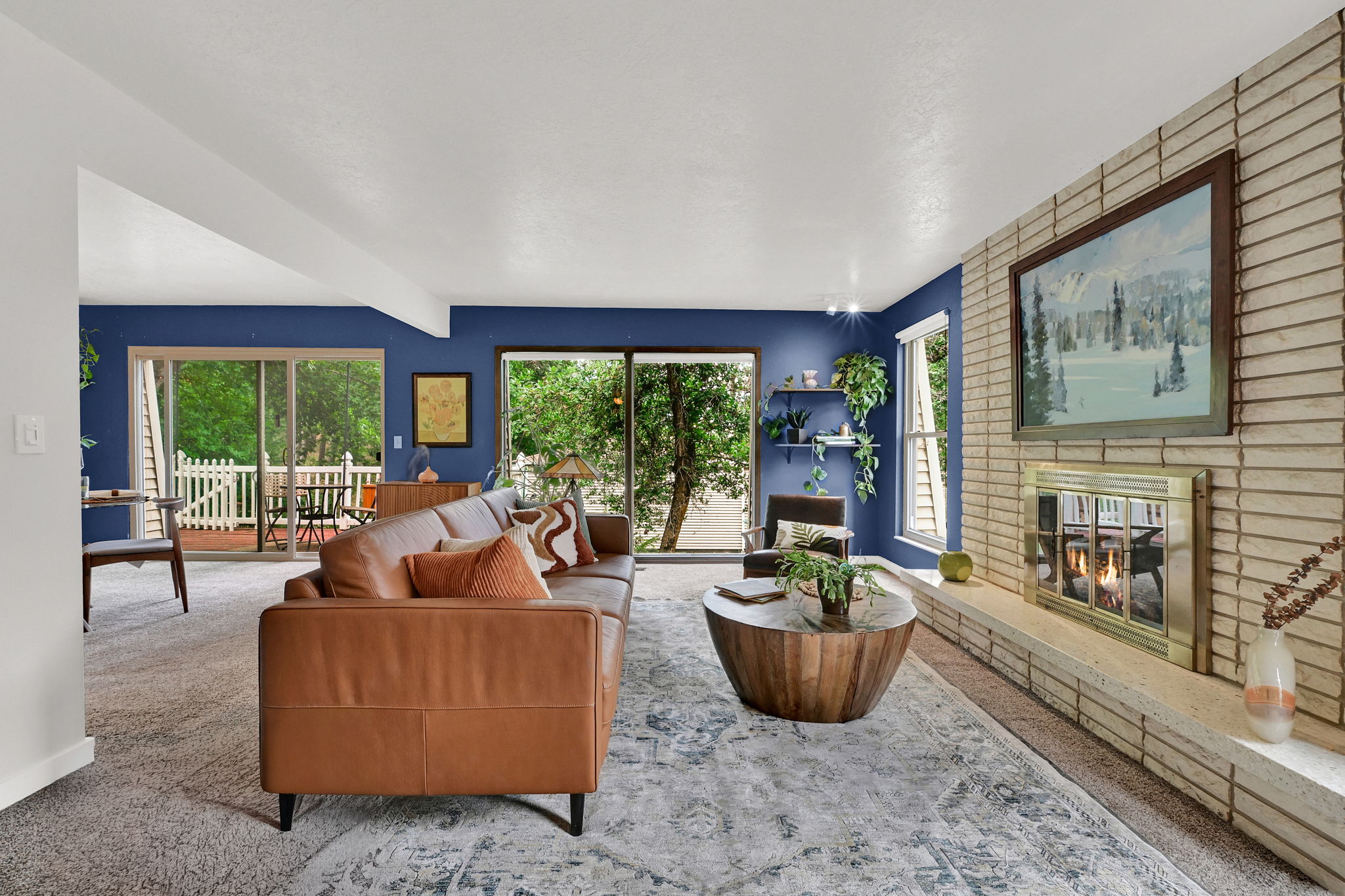 Living area with a floor-to-ceiling brick fireplace and  huge windows