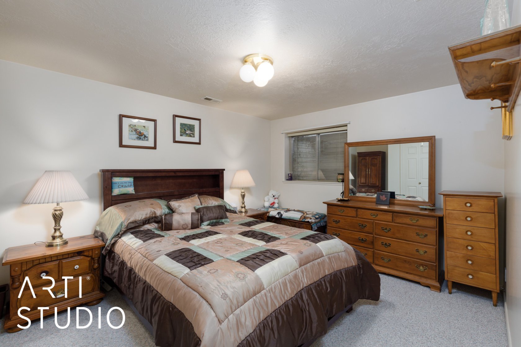 Bedroom featuring light carpet and a textured ceiling