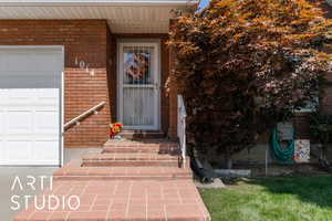 Doorway to property with brick siding