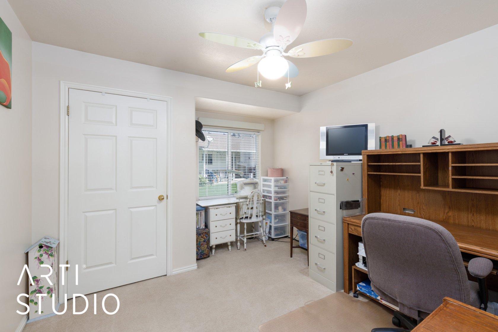 Office space featuring a ceiling fan and light carpet
