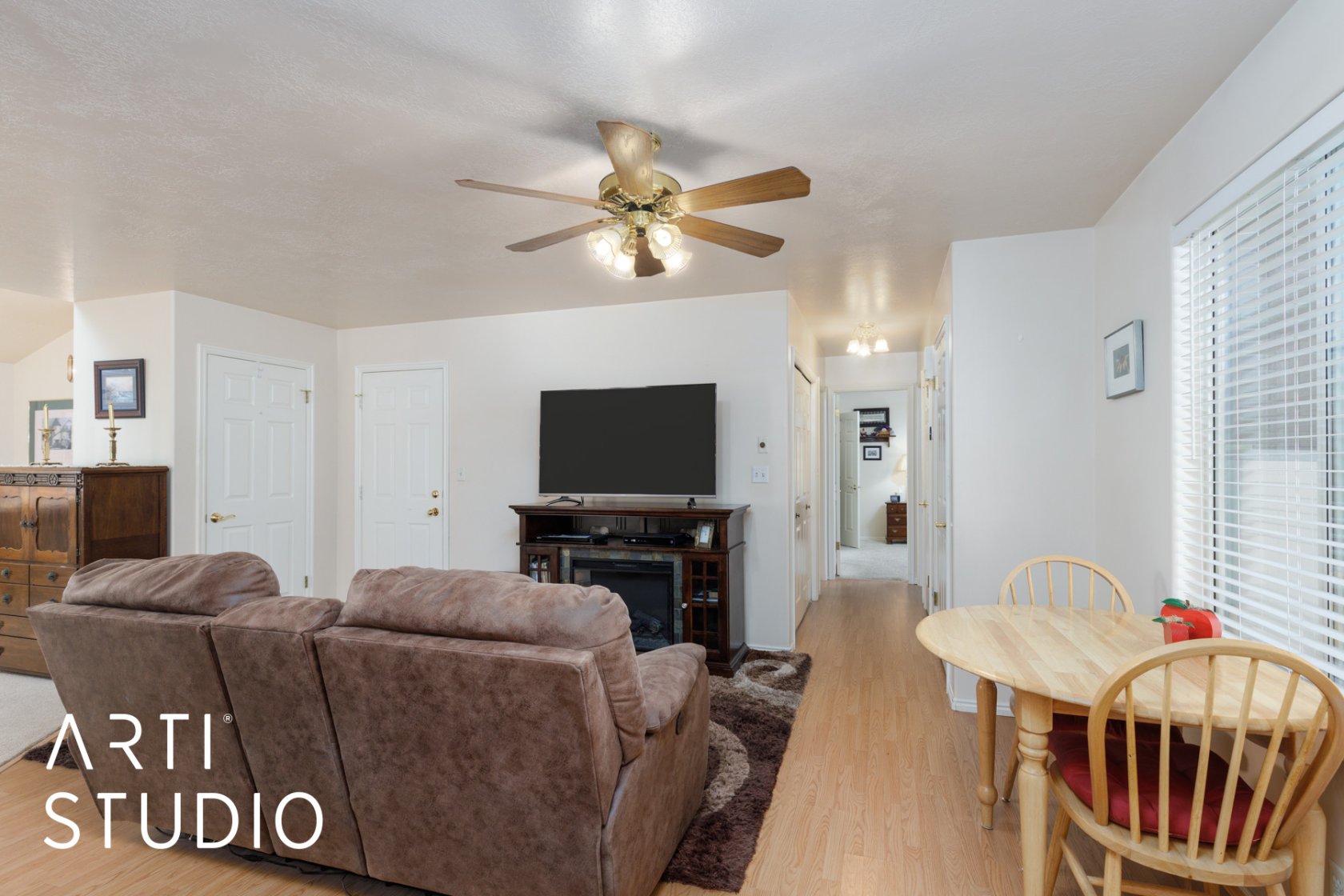 Living area with light wood finished floors and ceiling fan