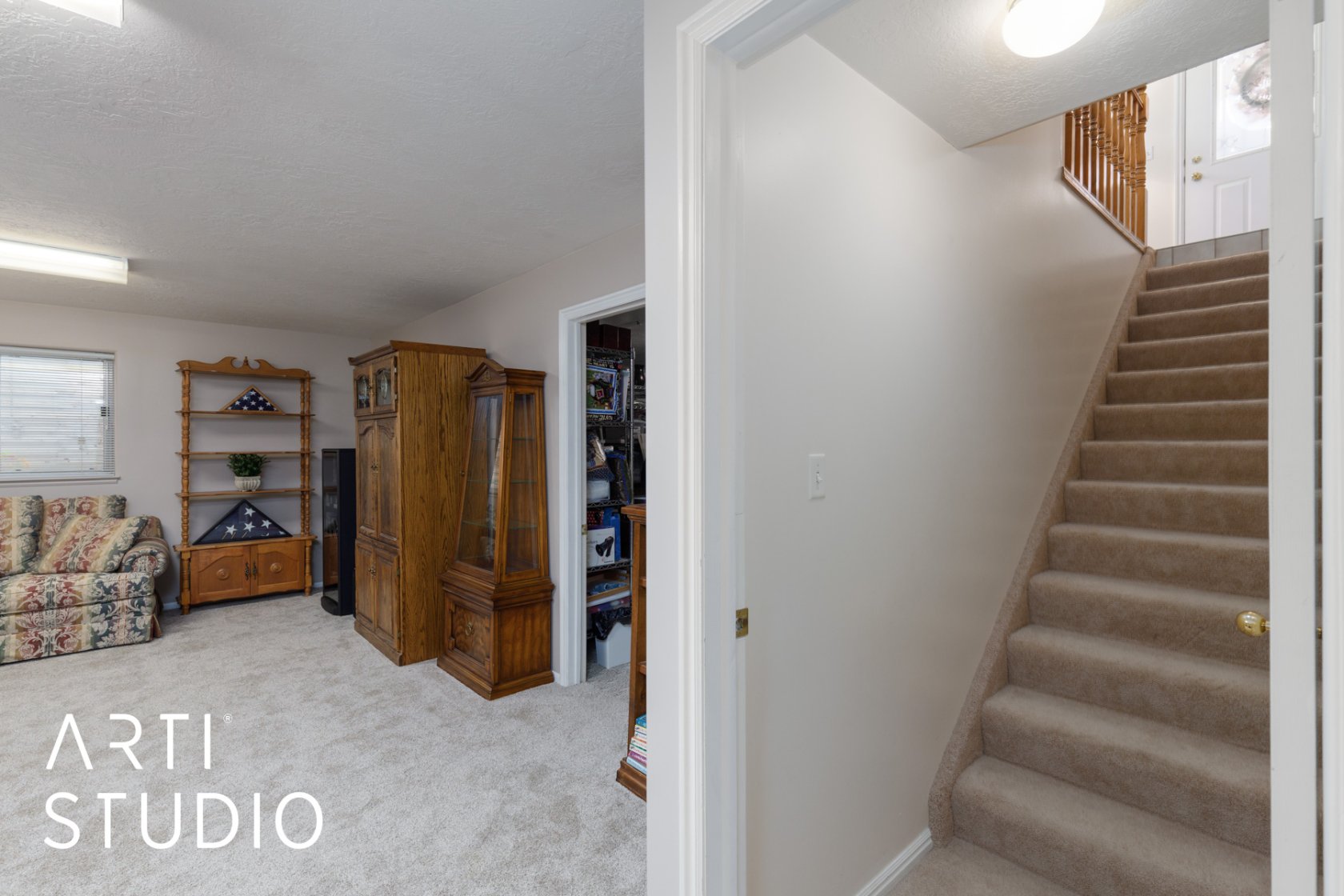 Stairs featuring carpet flooring and a textured ceiling