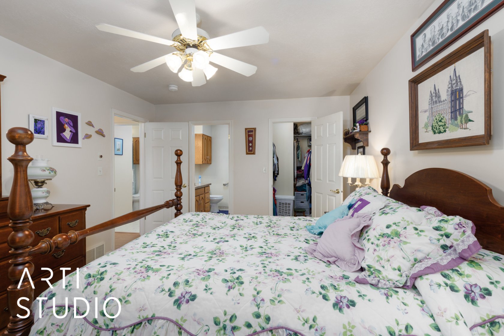 Bedroom with a walk in closet, ceiling fan, and ensuite bathroom