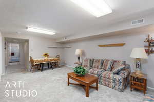 Living area with light colored carpet