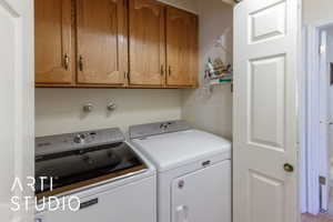 Laundry area featuring cabinet space and independent washer and dryer
