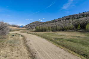 View of dirt / gravel road featuring a mountain view and a rural view