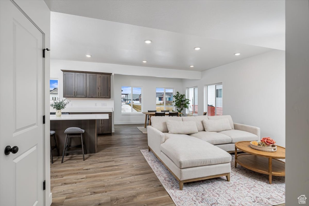 Living area featuring light wood-style floors and recessed lighting