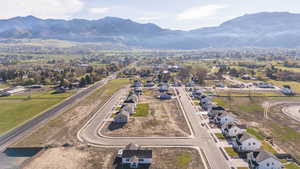 Aerial view of property's location featuring a mountain backdrop and nearby suburban area