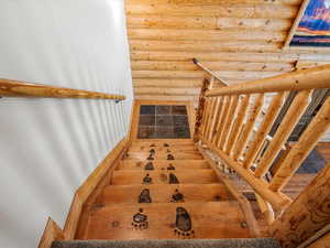Stairs featuring rustic walls