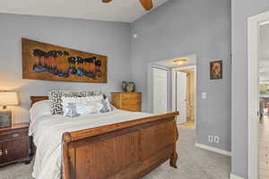 Bedroom featuring light carpet, a closet, ceiling fan, and vaulted ceiling