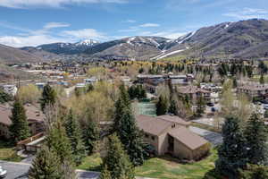 View of mountain backdrop featuring nearby suburban area