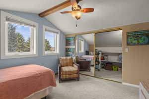 Bedroom with carpet flooring, ceiling fan, a closet, and beam ceiling