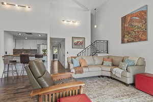 Living area featuring wood finished floors and a high ceiling