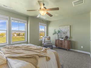 Primary Bedroom with carpet flooring and ceiling fan
