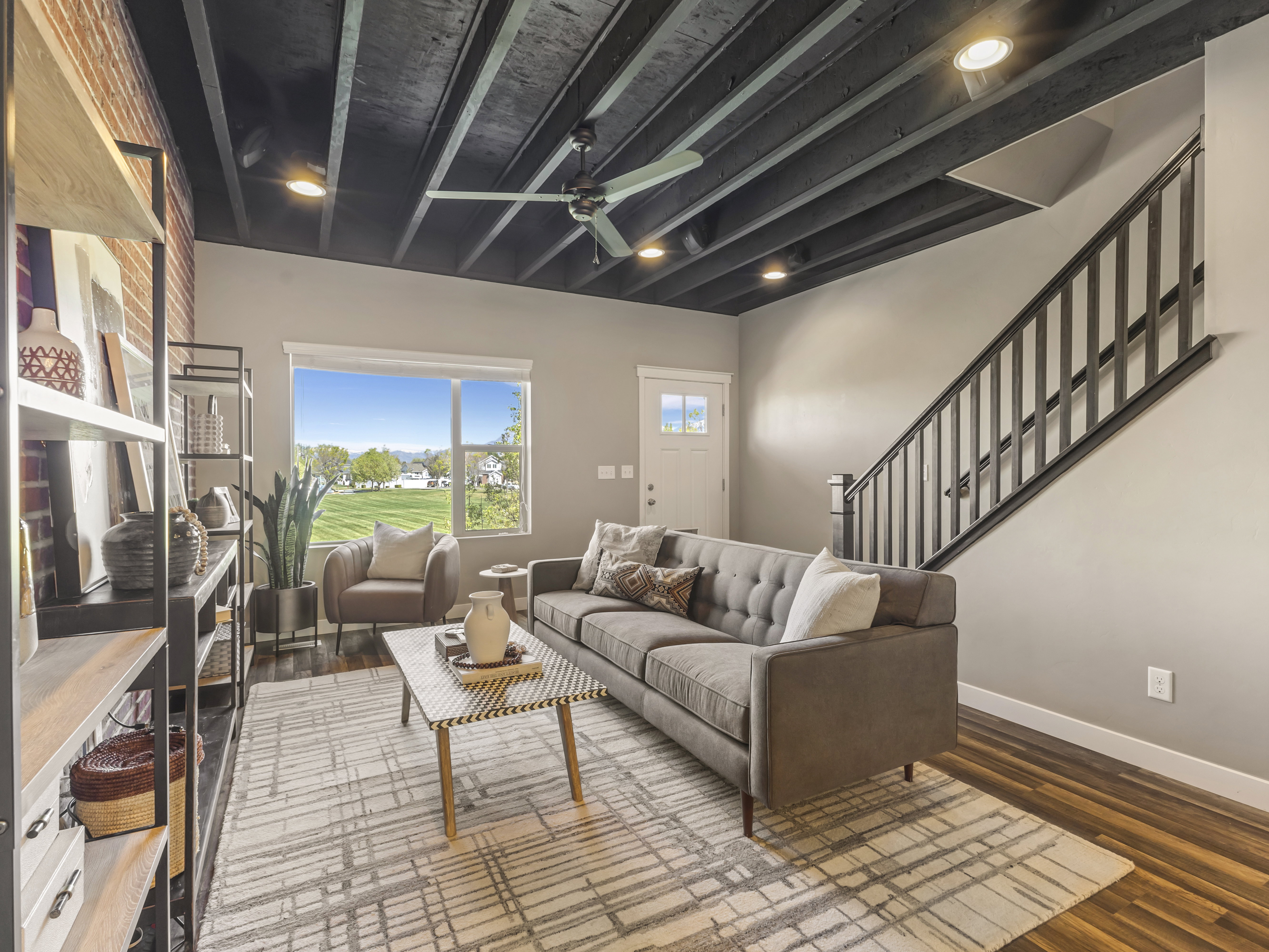 Living area featuring beam ceiling, a ceiling fan, wood finished floors, and recessed lighting