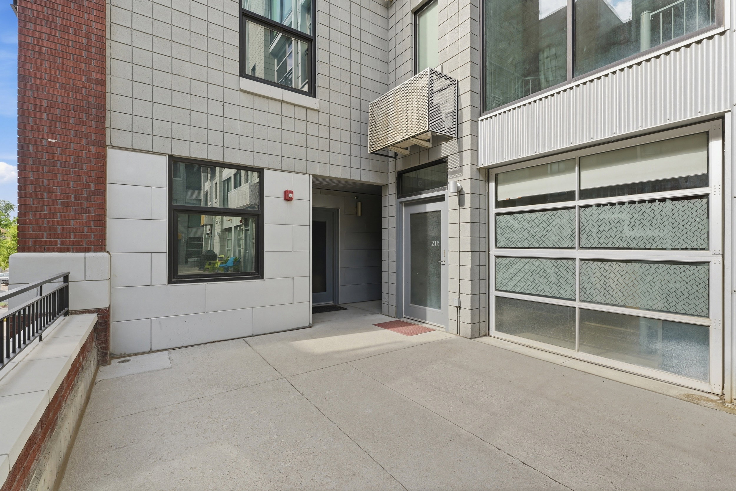 Contemporary building exterior featuring brick and light-colored block facade