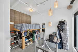 Bedroom featuring concrete floors and an accent wall