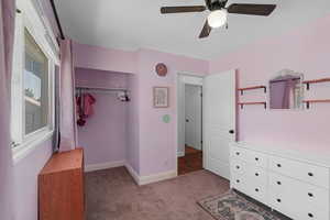 Unfurnished bedroom with light carpet, ceiling fan, and a closet