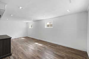 Below grade area with dark wood-style flooring and recessed lighting