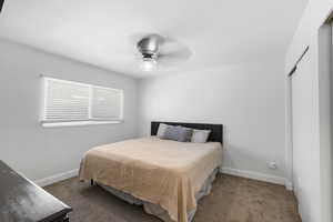 Bedroom with carpet flooring, ceiling fan, and a closet