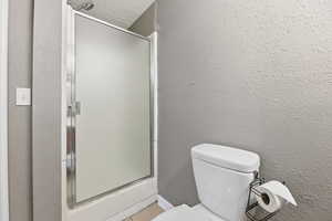 Three-quarter bathroom with shower stall