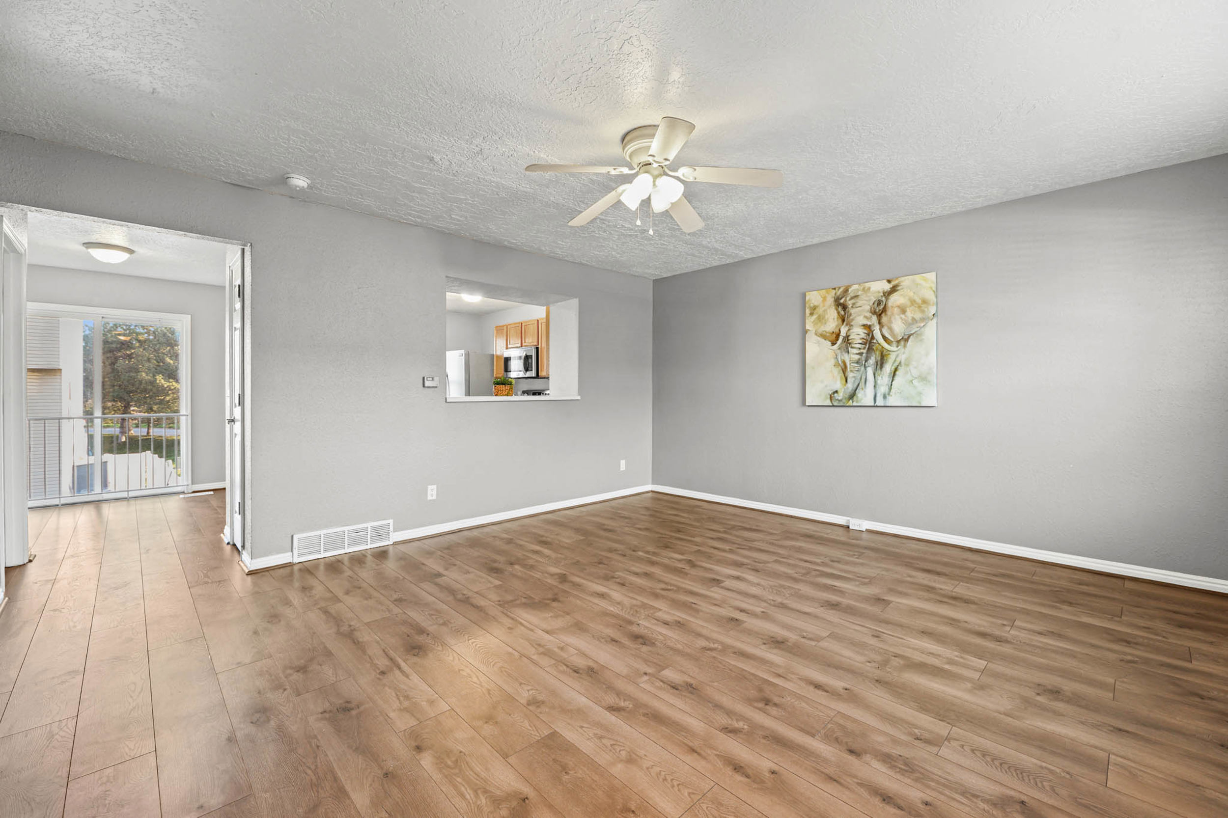 Living room featuring open bar window into the kitchen